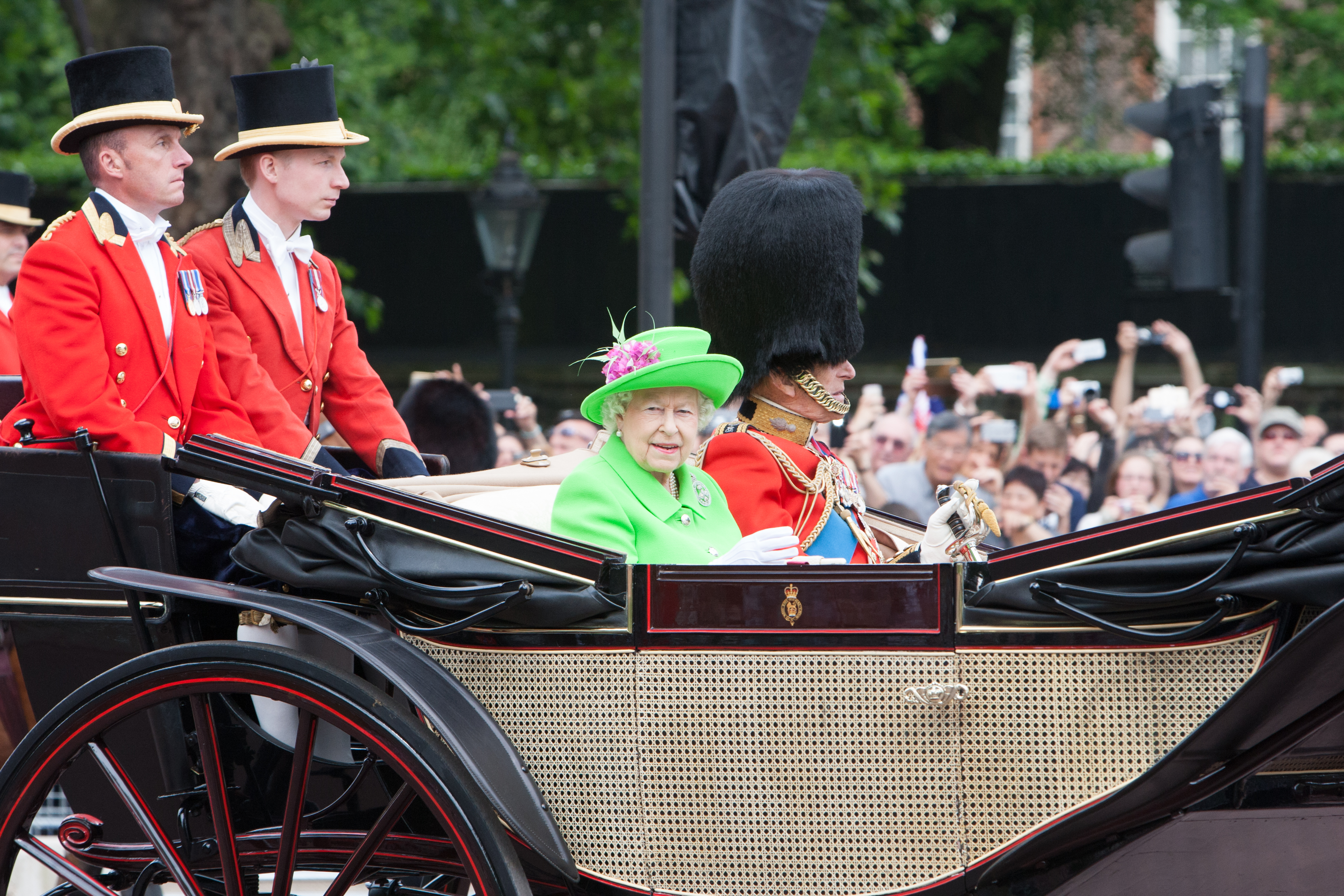 The Queen wearing a very striking neon outfit on the day